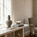 Elegantly curated living room corner with a console table displaying art objects and books, symbolizing personal design identity and enduring style.