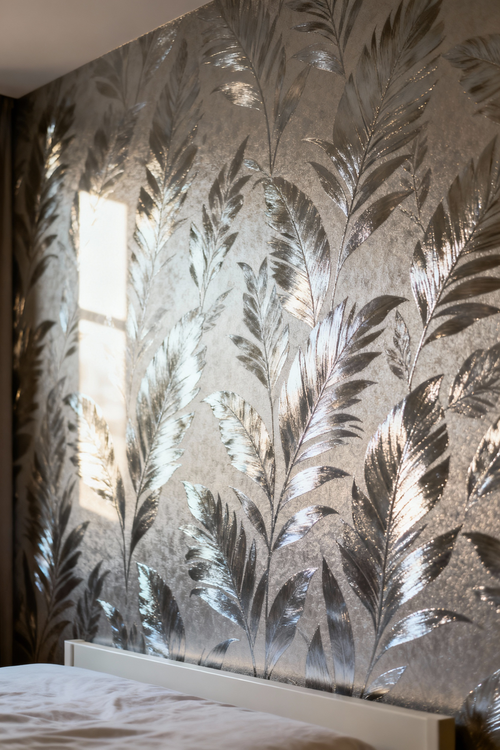 A luxurious bedroom accent wall covered in advanced composite wallpaper featuring a subtle metallic botanical pattern, reflecting soft light and enhancing the room's elegant depth.